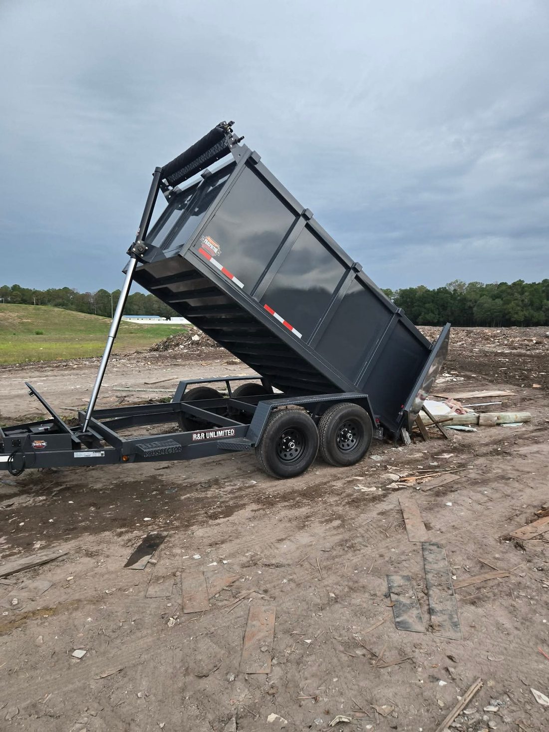 Lance & Load dump trailer tipping a full load at the dump after a property cleanout